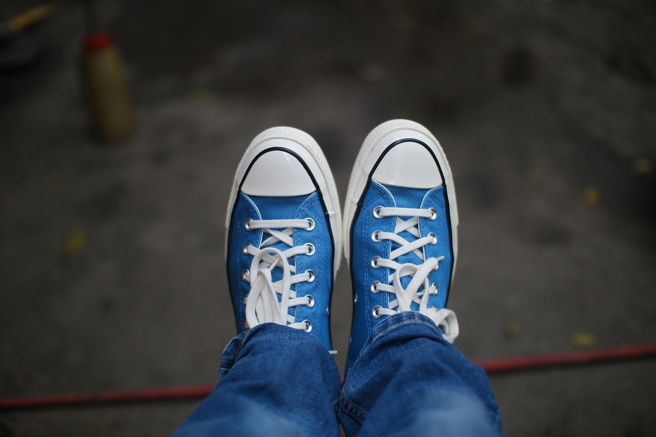 comfortable blue sneakers worn by a person